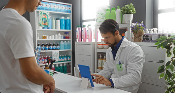 patient consulting with pharmacist in modern pharmacy