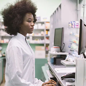 pharmacist working at computer - pharmacy workflow