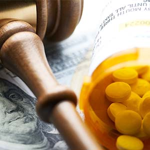 pills and gavel on money