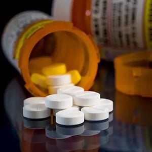 prescription-pills-and-bottles-on-reflective-surface-1