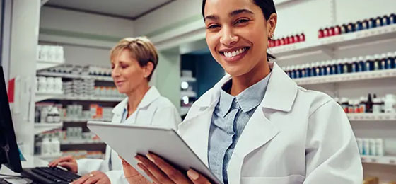 smiling pharmacist with tablet