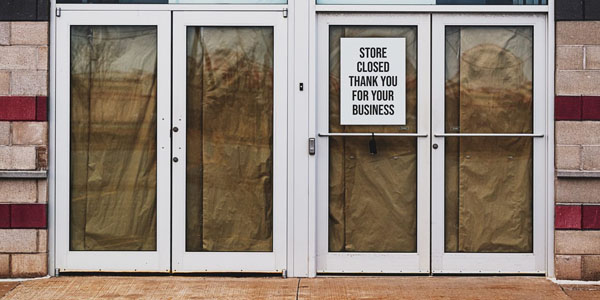 Building with store closed sign on door